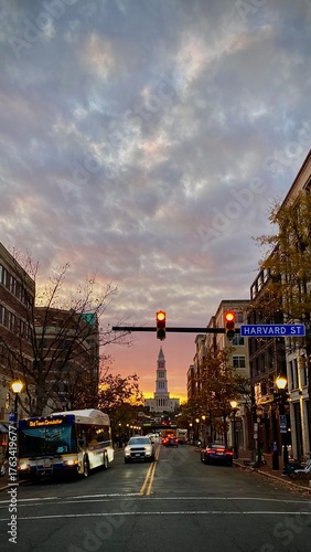 Street scene at sunset on Harvard Street with traffic and Capitol dome. Old Town Alexandria.
