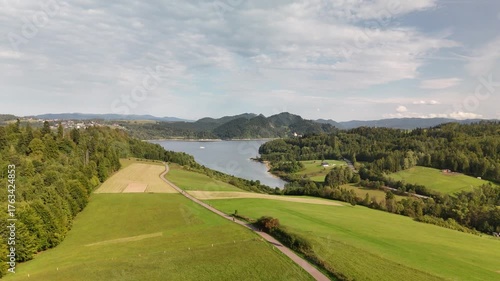 Scenic Aerial View of Czorsztyn Lake and Cycling Route in Southern Poland with Mountains, Forests and Green Valleys
