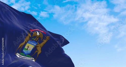 Michigan state flag waving in the wind on a clear day