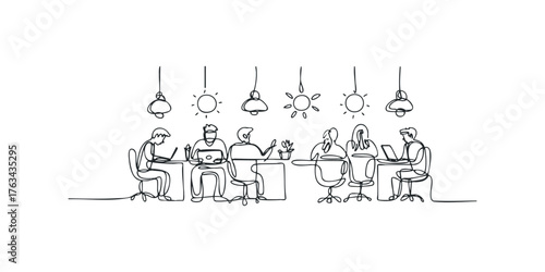 Group collaborating on laptops at desks with overhead lighting