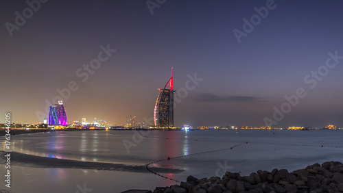 Fotografía Dubai skyline with Burj Al Arab hotel day to night timelapse.