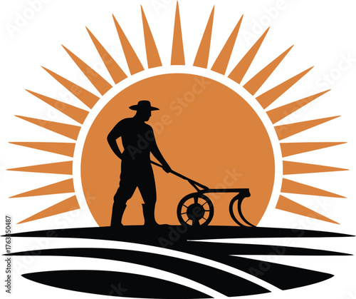 Farmer plowing a field with a tractor at sunrise silhouette