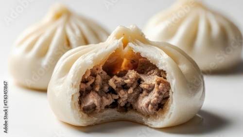 Irresistible savory steamed buns filled with tender seasoned meat, a delicious culinary delight perfect for any meal.