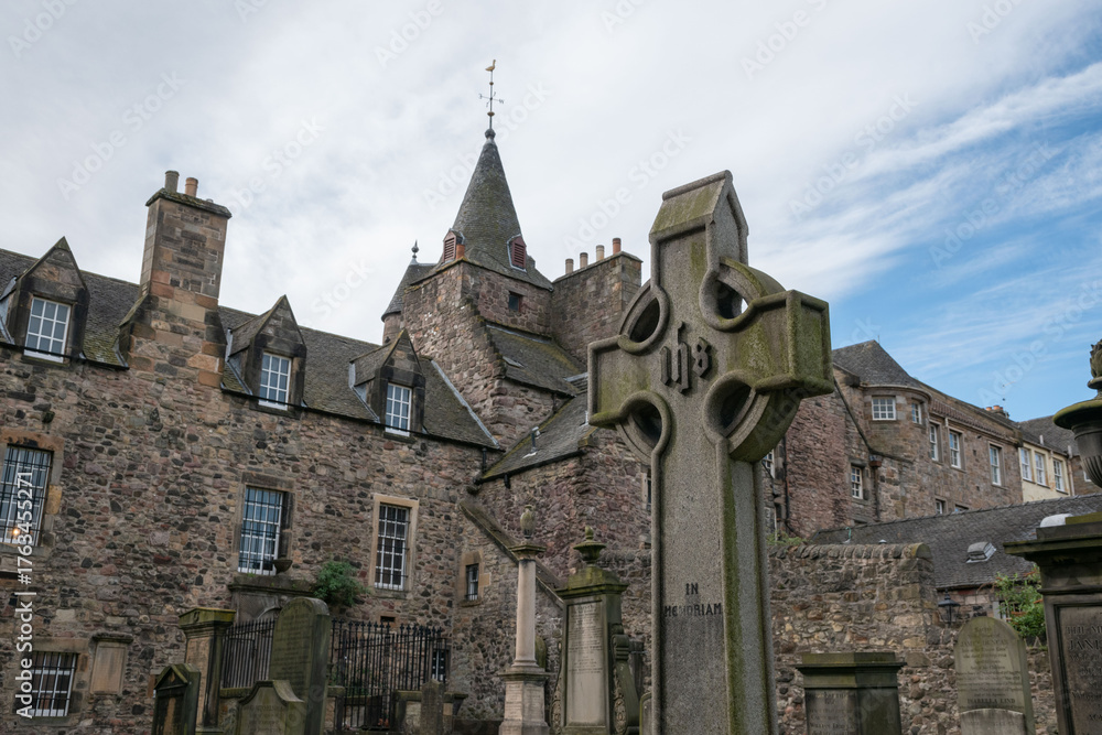 Fototapeta premium Edinburgh, Scotland - 13 April 2025. Historic Canongate Kirk and gravestones, a significant landmark in Edinburgh, showcasing architectural heritage and cultural history.