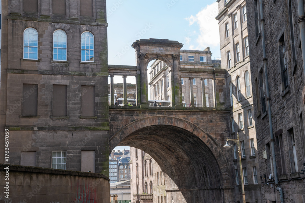 Fototapeta premium Edinburgh, UK - 13 April 2025. Regent Bridge in Edinburgh, Scotland, showcasing neoclassical architecture and urban heritage.