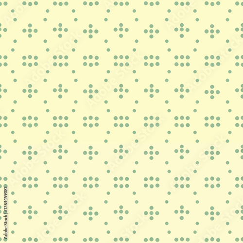 Seamless pattern with small green dots on a light yellow background.