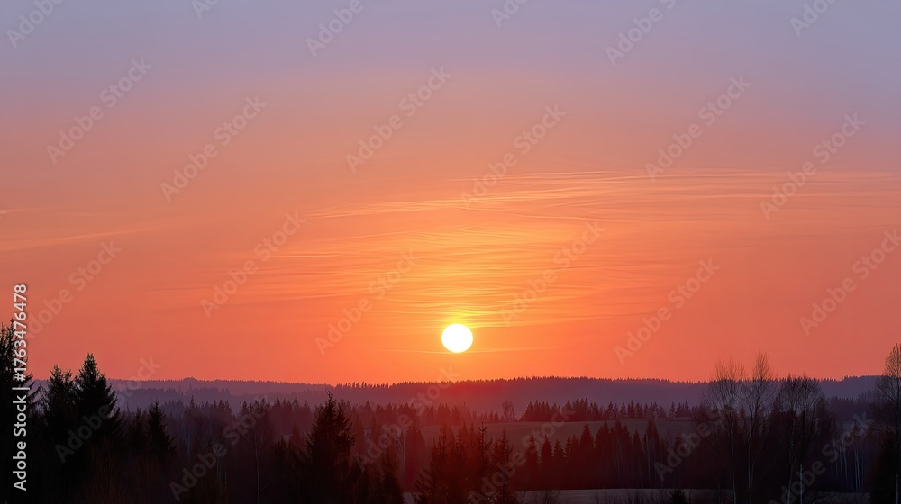 Obraz premium Serene Sunrise Over a Tranquil Landscape with Silhouetted Trees and Soft Sky Colors