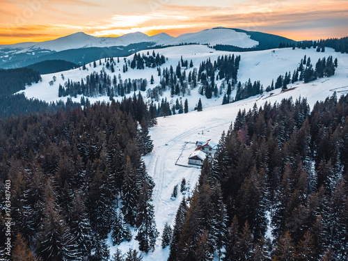Winter landscape in the Carpathian Mountains, Romania. Snow-covered peaks, frozen forests, and a peaceful mountain valley