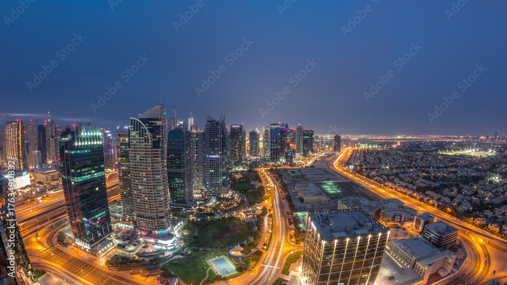Obraz premium Jumeirah Lake Towers residential district aerial day to night timelapse near Dubai Marina