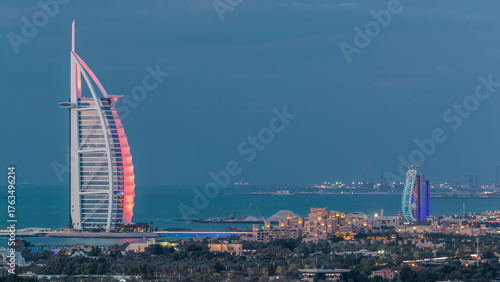 Aerial view of Burj Al Arab hotel from Internet city day to night timelapse.
