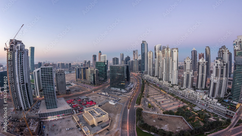Obraz premium Panorama of Business bay Dubai night to day aerial timelapse.