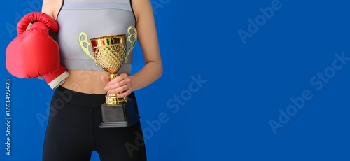 Female boxer with gold cup ...
