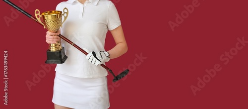 Female golfer with gold cup...