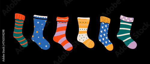 Colorful assortment of patterned socks on black background