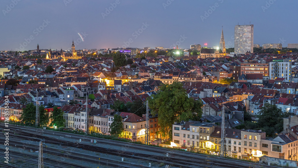 Obraz premium Aerial day to night timelapse panorama over Brussels skyline in Schaerbeek with Saint-Servais Church and Town Hall