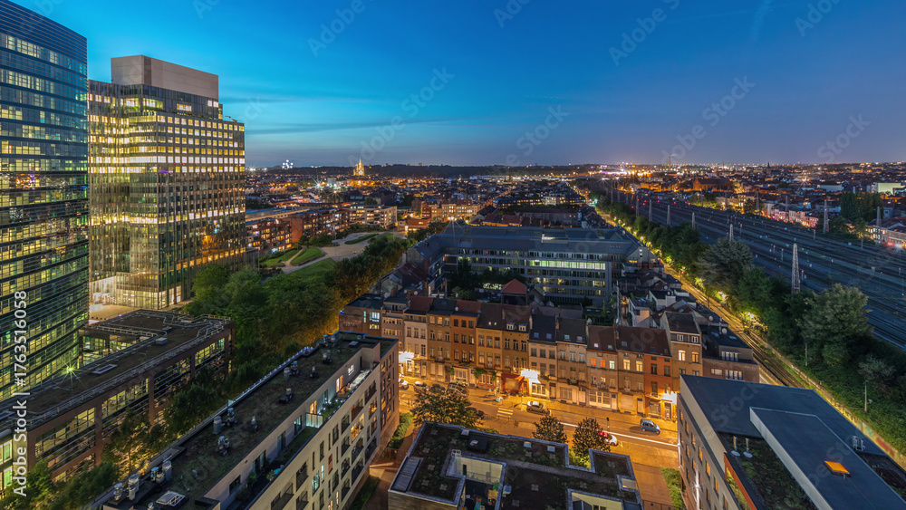 Obraz premium Aerial day to night timelapse of Brussels urban landscape blending office skyscrapers with residential areas.
