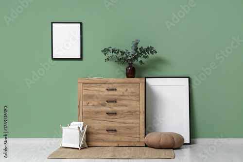 Wallpaper Mural Vase with eucalyptus twigs on chest of drawers near green wall in living room Torontodigital.ca