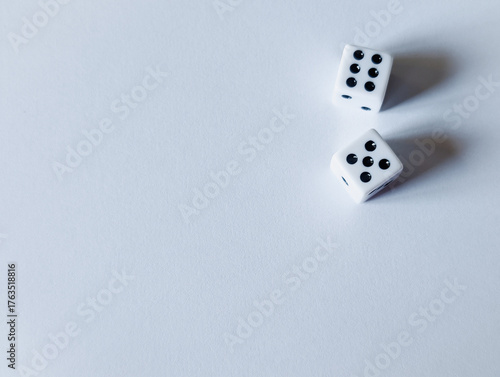 horizontal conceptual photo of two white dice showing six and five with massive copy space