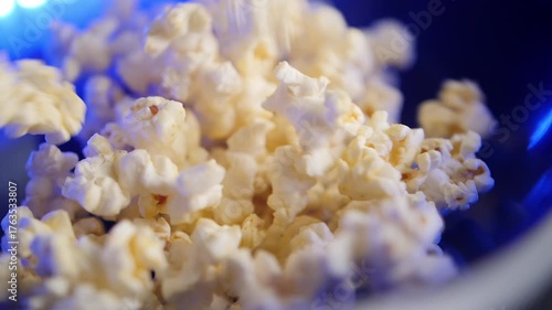 Slow motion macro shot of popcrorn falling down into a bowl