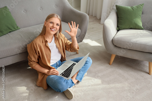 Young woman with laptop wav...