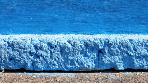 Vivid Azure Wall with Rough Texture and Concrete Ground Serene Minimalist Composition Tranquil Scene