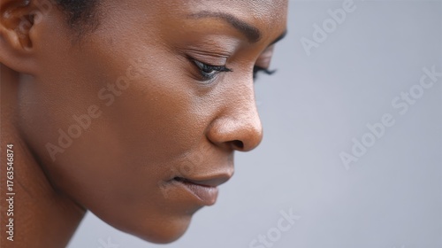 A close-up of a person thoughtful face looking slightly upward, symbolizing questioning life and purpose. Deep life questions and the meaning of life.