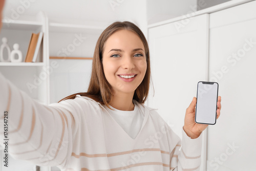 Young woman with blank mobi...