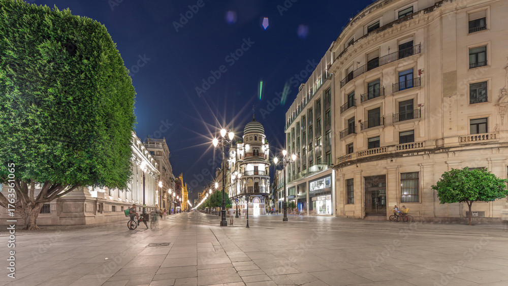 Obraz premium Illuminated Adriatica building on Avenida de la Constitucion at night, Seville, Spain