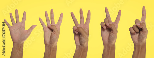 Set of Asian Hands Showing Numbers One to Five on Yellow Background with Clipping Path