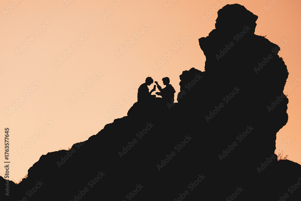 Naklejka premium A couple in love is sitting on a rock and talking