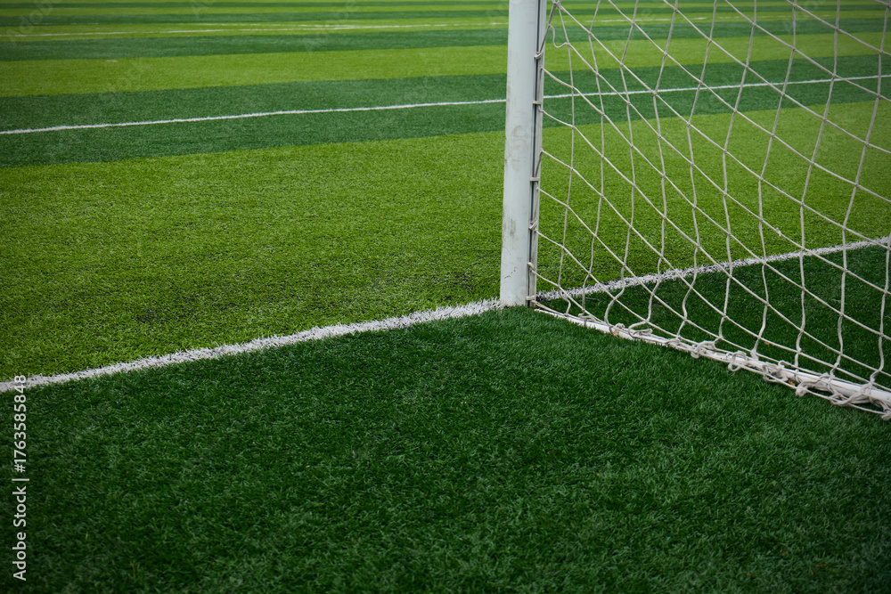 Fototapeta premium Soccer goal net on a brightly colored turf field