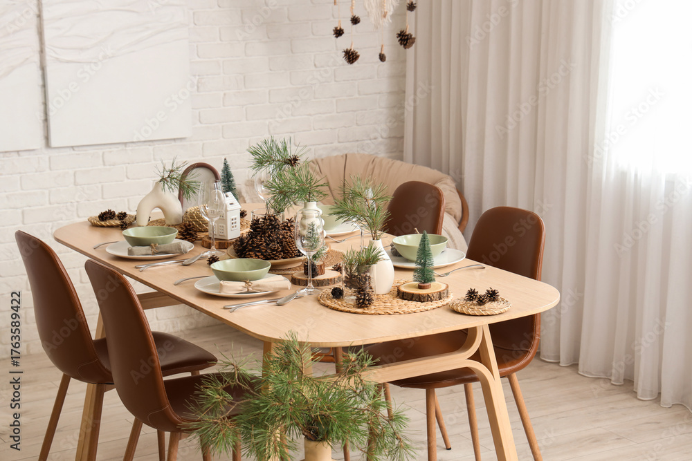 Obraz premium Dining table set with pine cones and branches in room