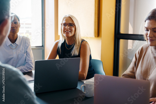 Photos Professional women collaborating in an office setting during a team meeting