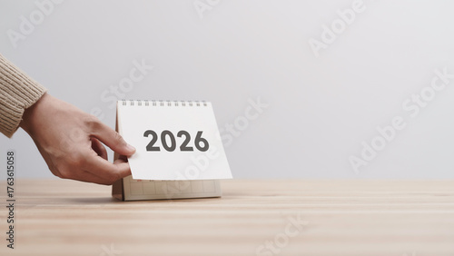 Wallpaper Mural Business woman hand change 2026 Year Calendar on table in office background. countdown to Happy New Year, Year End and New Start, Resolution and Goals Plan Action Concept. Schedule in 2026 Torontodigital.ca
