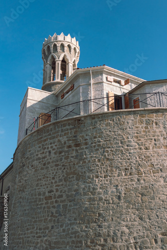 Historic stone tower with crenellations and shutters in Piran, Adriatic coast