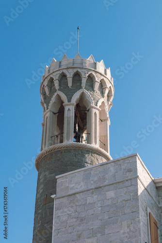 Medieval stone tower with arched openings and crenellations in Piran, Adriatic coast