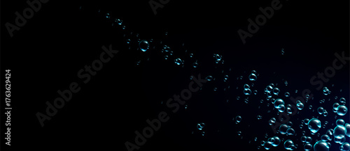 Blue water bubbles rising upward on a dark background