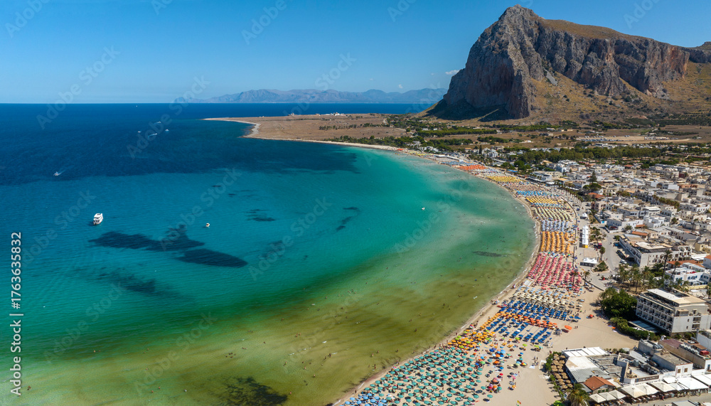 Fototapeta premium Aerial view of the bay of San Vito Lo Capo, a tourist destination in province of Trapani, Sicily, Italy. It has a beautiful beach overlooking the Mediterranean Sea, visited by tourists every summer.