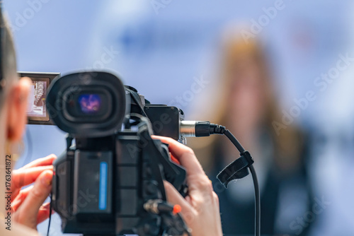 Camera at press conference records key statements, ensuring accurate media coverage. Its precise footage preserves critical details, supporting transparent public communication.