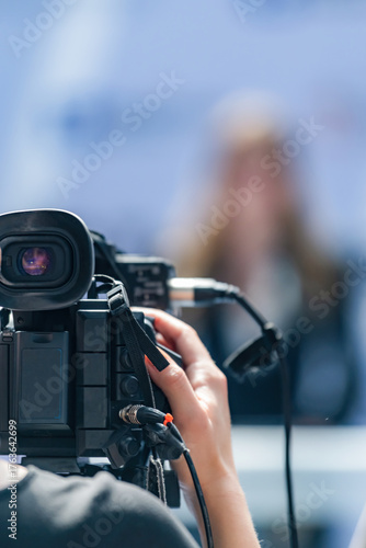 Recording a media press conference with a camera preserves accurate details. It ensures clear visuals and audio, supporting transparent communication and public access to information.