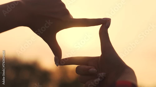 girl child shows hand gesture to take a photo. travel adventure tourism concept. girl child hand lifestyle depicts square frame hands gesture to take a photo