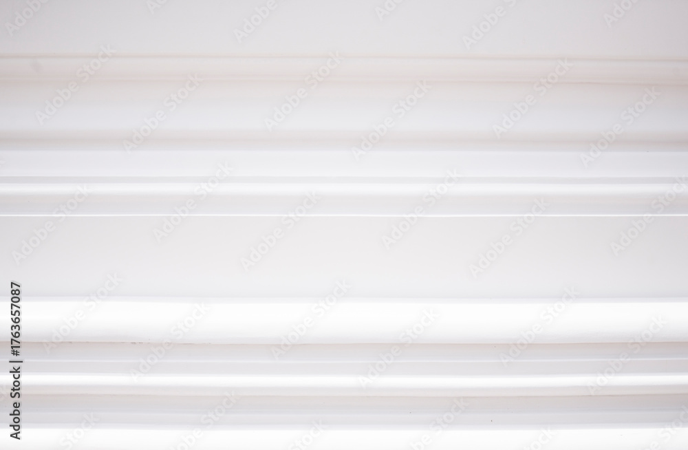 Fototapeta premium White window blinds on the white wall. Abstract background and texture for design.