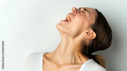 Intense Emotion of Woman Scream of Distress with Neutral Background, Hair Pulled Back, and Facial Expression Reflecting Deep Feelings of Sadness and Discomfort