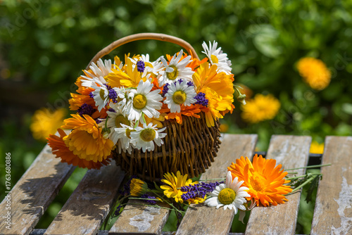 Beautiful fresh summer flowers in wicker basket