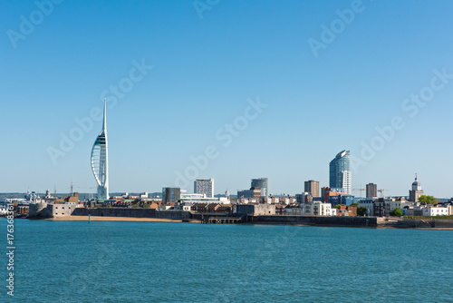 Landscape view of the entrance to Portsmouth harbour with The Spinnaker Tower Sail of the Solent landmark against a blue sky background