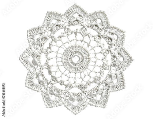 Intricate white crocheted doily, circular with a floral design and delicate lace