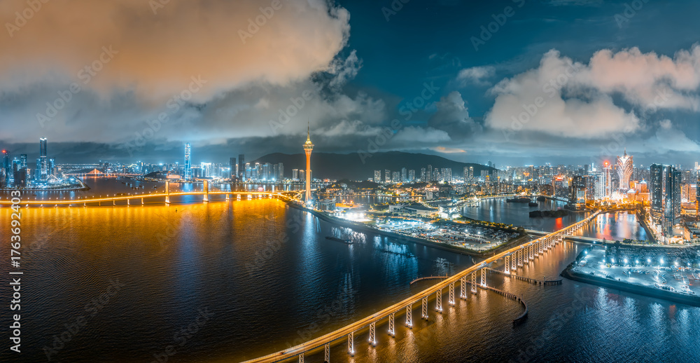 Fototapeta premium Macau modern city skyline and business buildings with bridge at night.