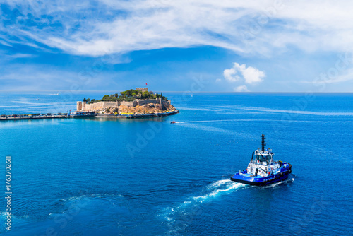 Pigeon Island (Güvercinada) Fortress with boat, Kusadası, Aydin, Turkey
