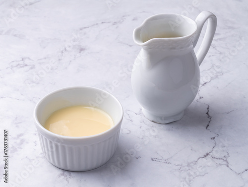 Condensed milk in a bowl over marble table