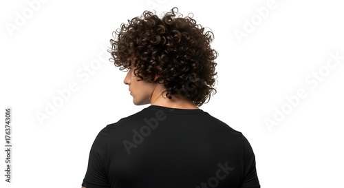 A young man with curly hair is seen from behind, isolated on transparent background, wearing a black tshirt and looking to the side in studio shot